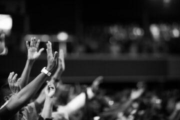 grayscale photography of hands waving