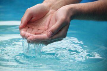 person s scooping water by hands