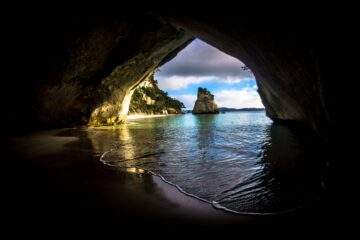 gray and brown cave near on the ocean