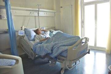 photo of woman lying in hospital bed